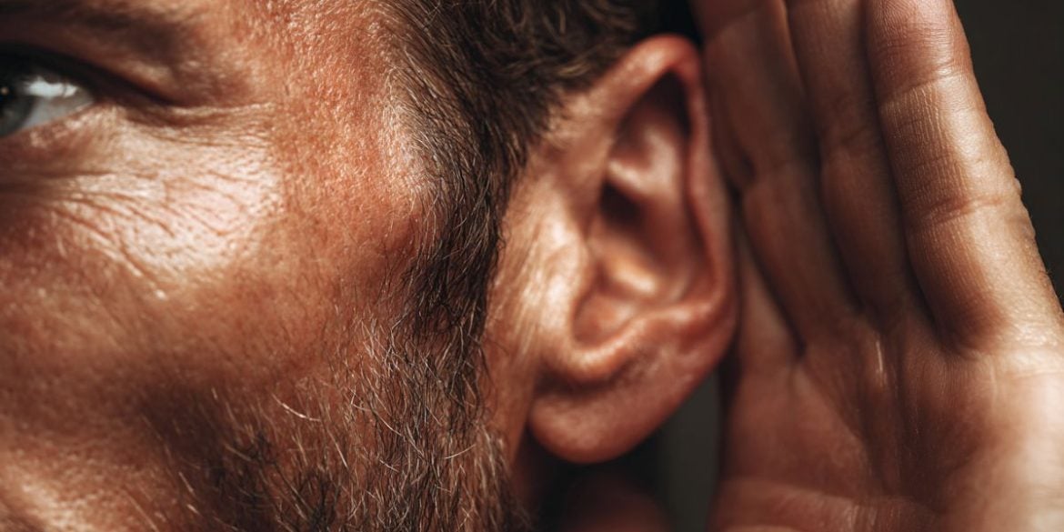 This shows a man cupping his ear.