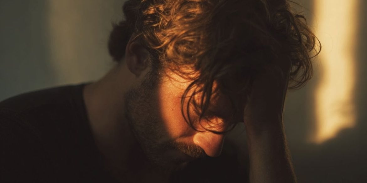 This shows a man holding his head.