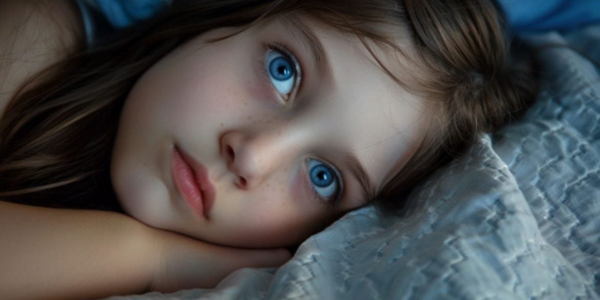 This shows a little girl laying awake.